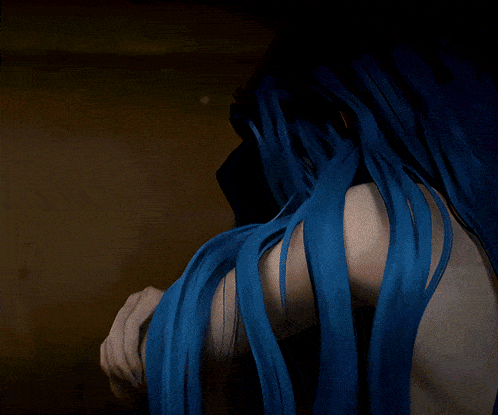 a person with blue hair is being touched by another person