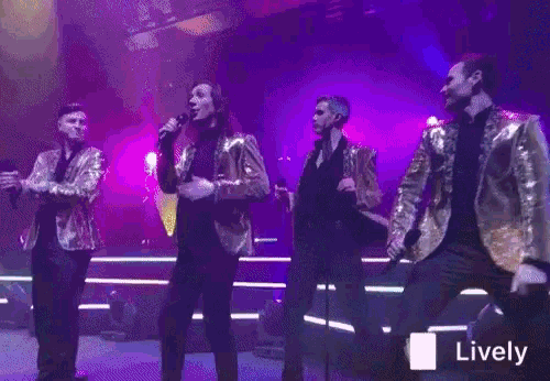 a group of men singing and dancing on a stage with a lively sticker