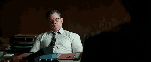 a man in a suit and tie is sitting at a desk and saying i 'm sorry for his loss