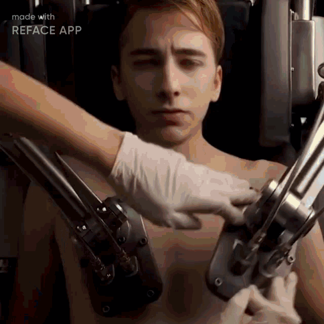 a man without a shirt is being operated on by a machine .