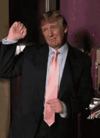 donald trump is wearing a suit and tie and dancing