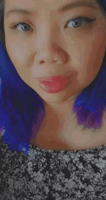 a close up of a woman with blue hair