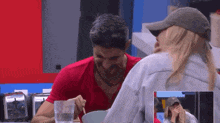 a man and a woman are sitting at a table eating food