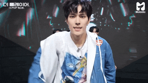 a man wearing a blue jacket and a white t-shirt with a picture of a woman on it