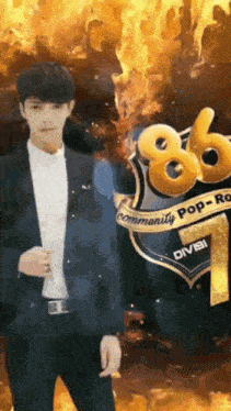 a man in a suit stands in front of a sign with the number 86 on it
