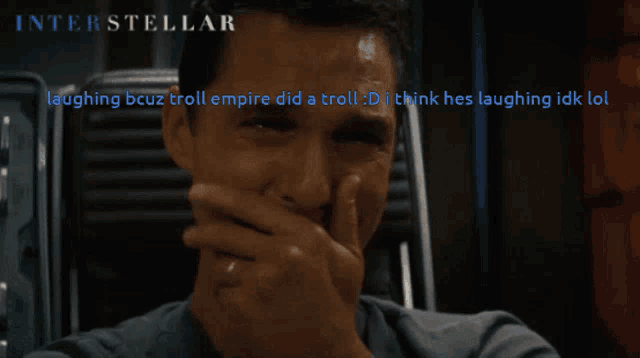 a poster for interstellar shows a man laughing while covering his mouth