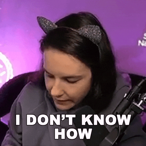 a woman wearing cat ears is sitting in front of a microphone and saying `` i don 't know how ''