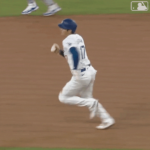 a close up of a baseball player 's feet on a baseball field