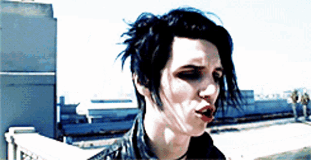 a woman with short black hair is making a face