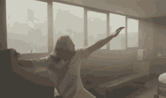 a man with his arms outstretched in a room