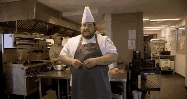 a chef in a kitchen with a sign that says no smoking on it