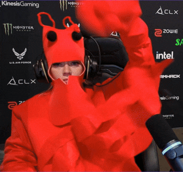 a woman in a red monster costume is sitting in front of a clx banner