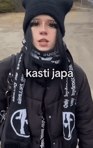 a woman wearing a black hat and a scarf with the word kasti japa on it