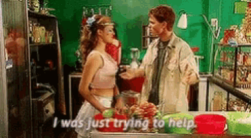 a man and a woman are talking in a kitchen and the woman is saying i was just trying to help