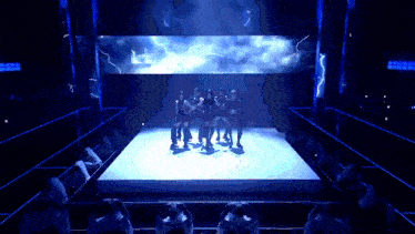 a group of people are standing on a stage in front of a large screen with lightning bolts