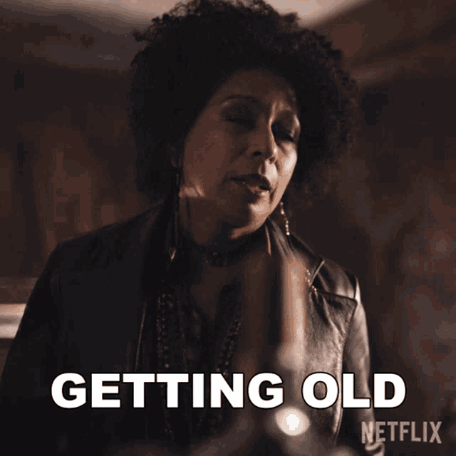 a woman in a leather jacket is getting old