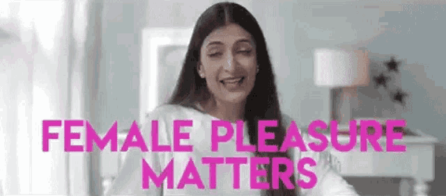 a woman is standing in a room with the words `` female pleasure matters '' written on the screen .