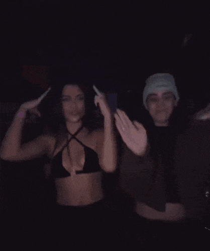 a man and a woman are dancing in the dark