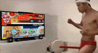 a man in red underwear is playing a video game on a television .