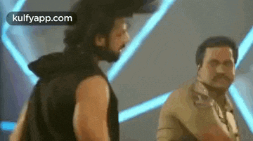 a couple of men are standing next to each other in a room .