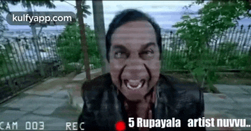 a man is making a funny face in front of a camera while wearing a black jacket .