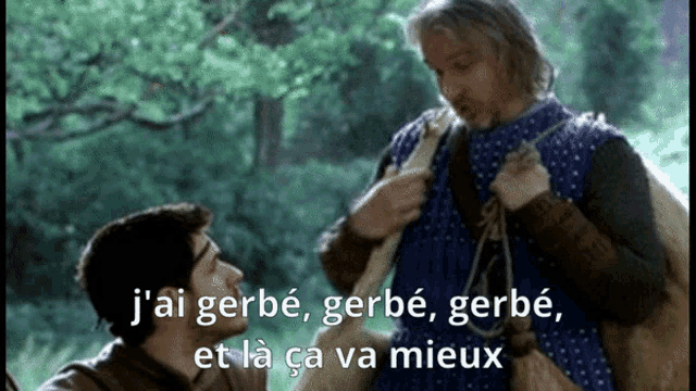 a man in a blue dress is talking to another man in a forest