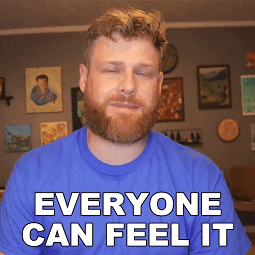 a man with a beard wearing a blue shirt says everyone can feel it
