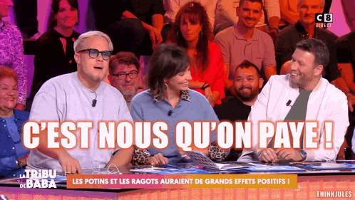 a group of people are sitting in front of a screen that says c'est nous qu'on paye !