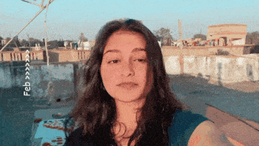 a woman taking a selfie with the date february on the bottom right