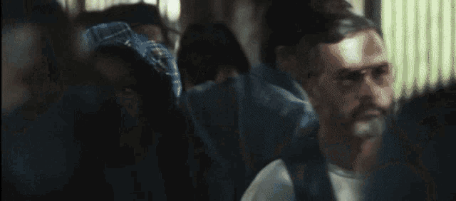 a man and a woman are sitting in a crowd