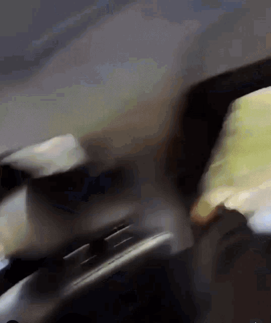 a blurry picture of a person in a car looking out the window