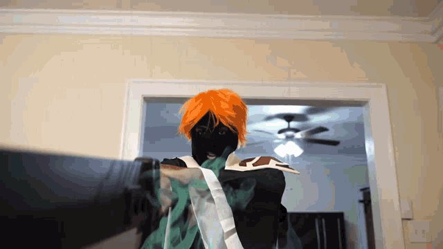 a person with orange hair and a black mask is standing in a room