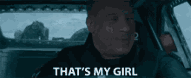 a man is driving a car and saying that 's my girl .