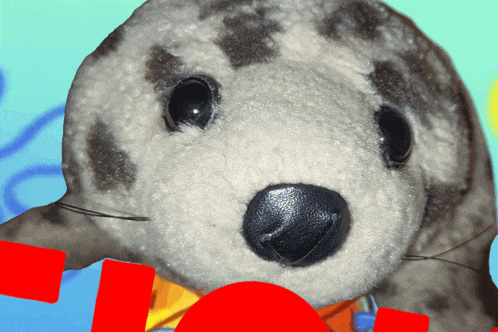 a stuffed seal with a red circle in the middle