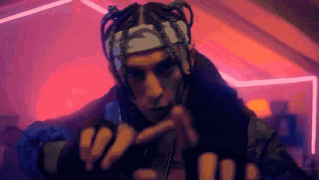 a man with dreadlocks wearing a headband that says ' supreme ' on it