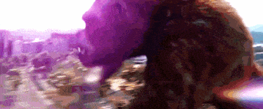 a blurry picture of a woman 's face with a purple background