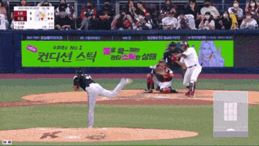 a baseball game is being played in front of a large screen that says no 1