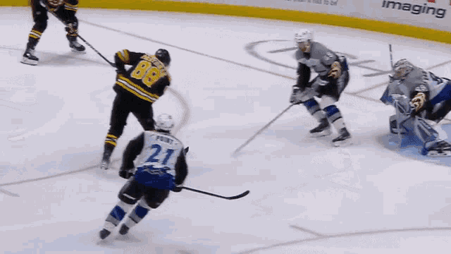 a hockey player with the number 21 on his jersey is skating on the ice