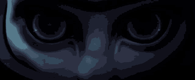a close up of a person 's face in the dark