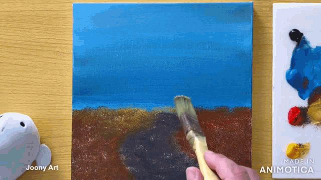 a painting is being painted on a canvas with the words made in animatica on the bottom right