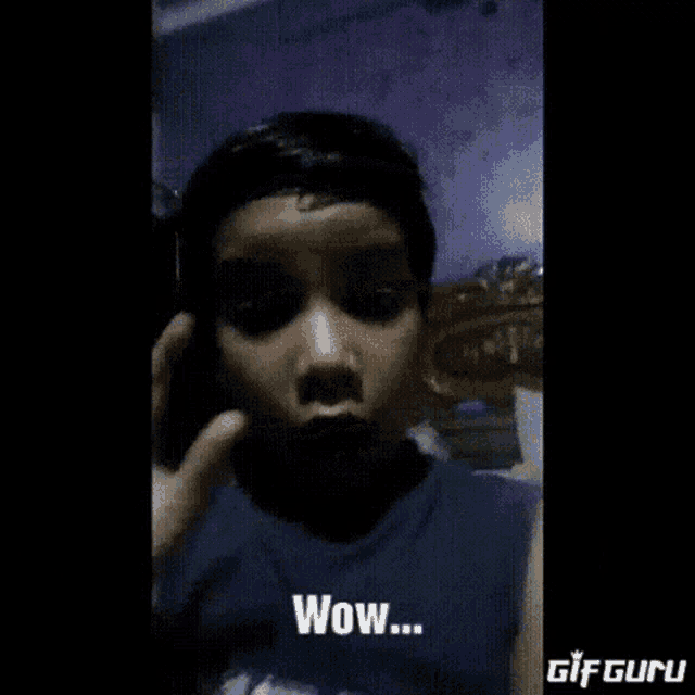 a young boy is making a surprised face with the words wow written on the bottom