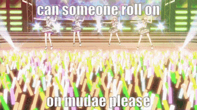 a group of girls are dancing on a stage with the words `` can someone roll on on mudae please '' written on the bottom .