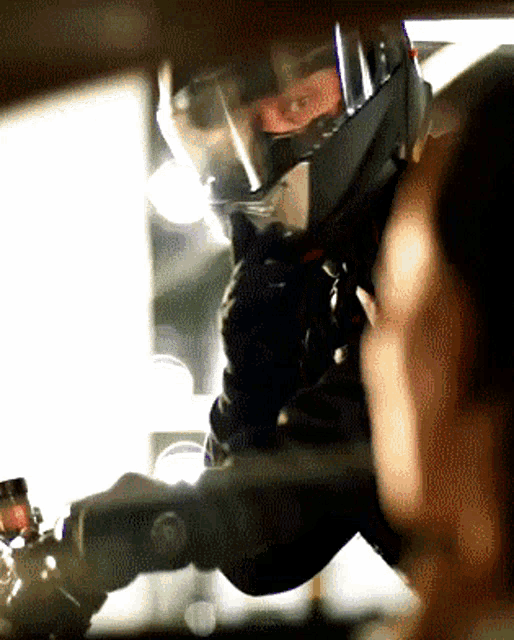a close up of a person wearing a helmet and gloves