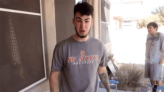 a man wearing a vc state wolfpack shirt