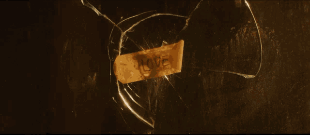 a bullet hole in a broken glass with a hole in the middle