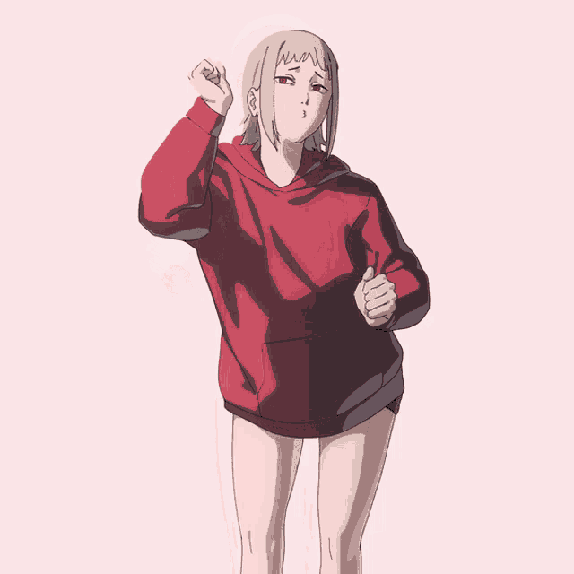 a girl in a red hoodie is making a face
