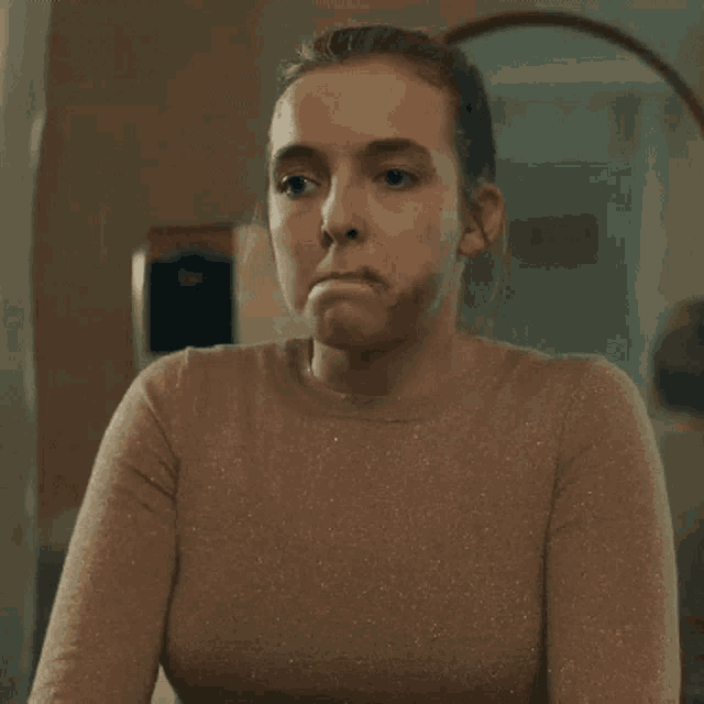 a woman with makeup on her face is making a face .