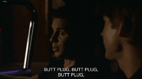 a man in a car is talking to another man who says butt plug