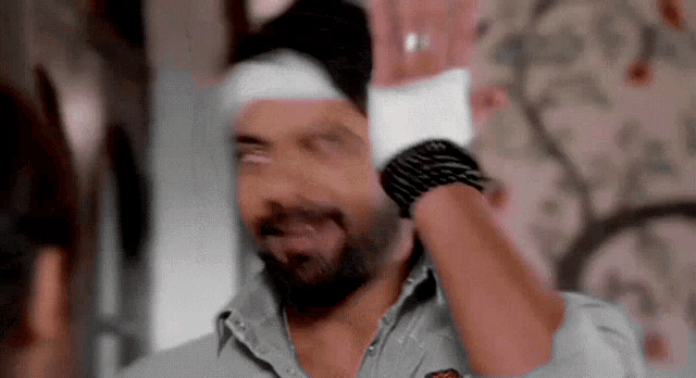 a man with a bandage on his head and a glove on his wrist