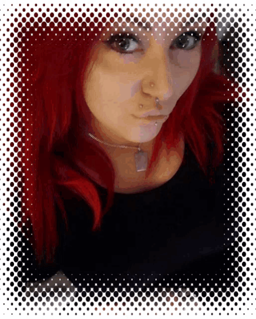 a woman with red hair is wearing a black shirt and a silver necklace